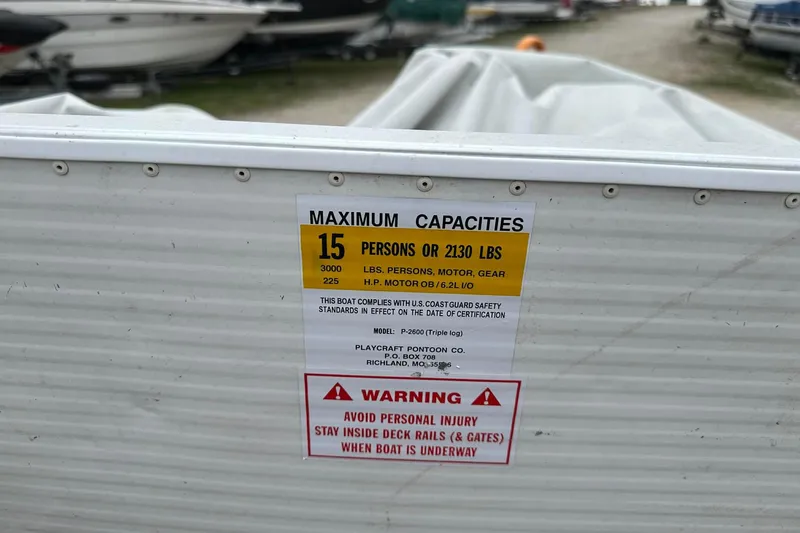 Slide: The Image of 2004 PlayCraft Powertoon 26 capacity label, 15 persons or 2130 lbs, safety warning. - 16