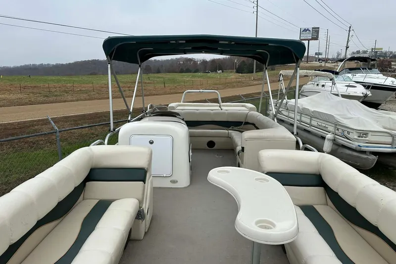 Slide: The Image of 2004 PlayCraft Powertoon 26 pontoon boat with spacious seating and canopy. - 18