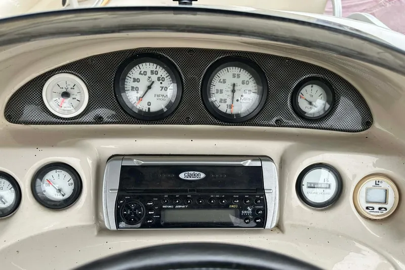 Slide: The Image of Dashboard of a 2004 PlayCraft Powertoon 26 with gauges and Clarion stereo system. - 4