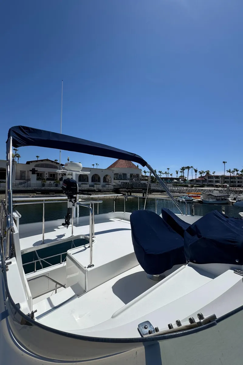 Slide: The Image of 2001 Zeta Flybridge Power Catamaran docked under clear blue sky. - 14