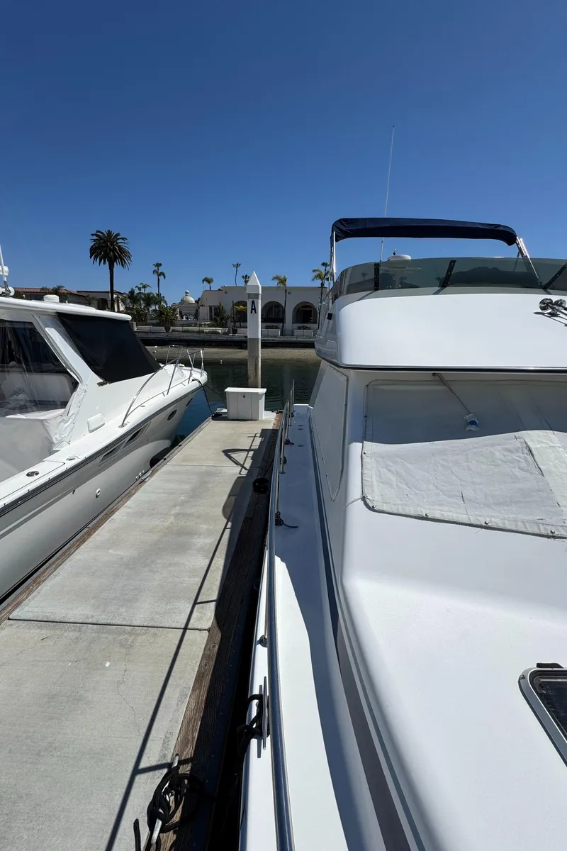 Slide: The Image of 2001 Zeta Flybridge Power Catamaran docked at marina under clear blue sky. - 15