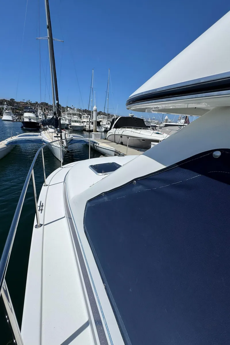 Slide: The Image of 2001 Zeta Flybridge Power Catamaran docked in a marina under clear blue skies. - 23