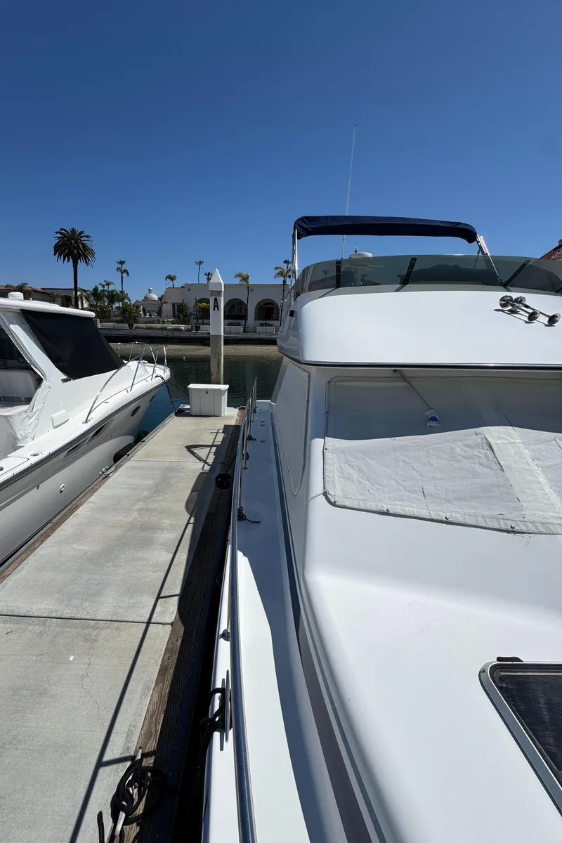 Slide: The Image of 2001 Zeta Flybridge Power Catamaran docked under clear blue sky. - 28