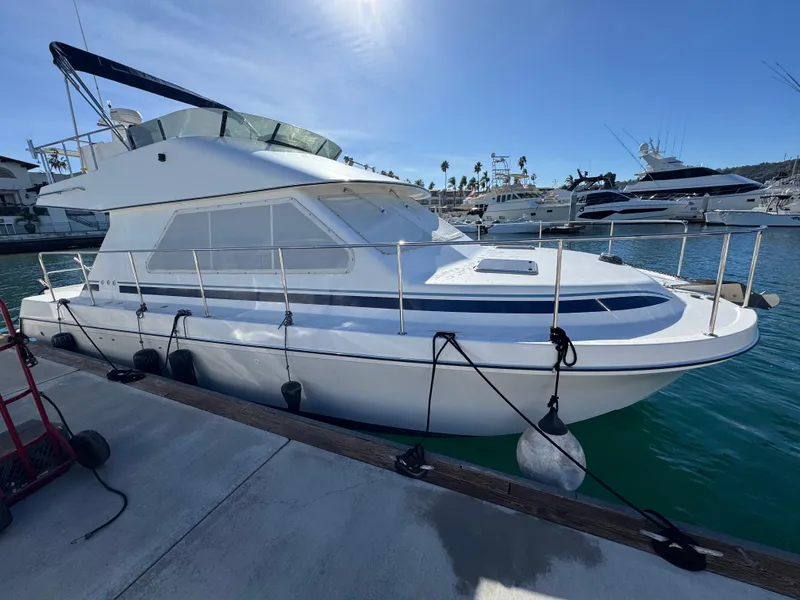Slide: The Image of 2001 Zeta Flybridge Power Catamaran docked in a sunny marina. - 3