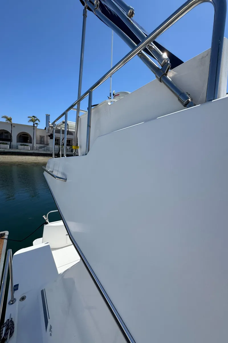 Slide: The Image of 2001 Zeta Flybridge Power Catamaran, sleek white exterior, docked in sunny marina. - 31