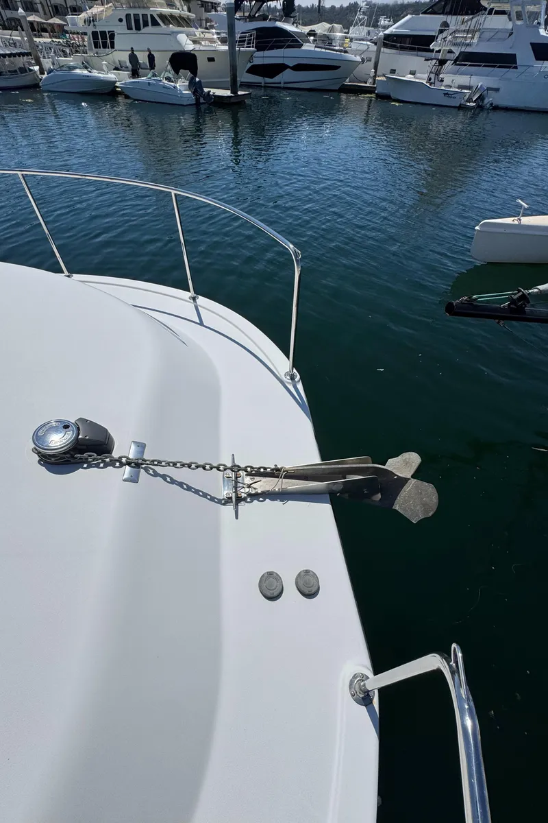 Slide: The Image of Bow of 2001 Zeta Flybridge Power Catamaran with anchor, docked in marina. - 32