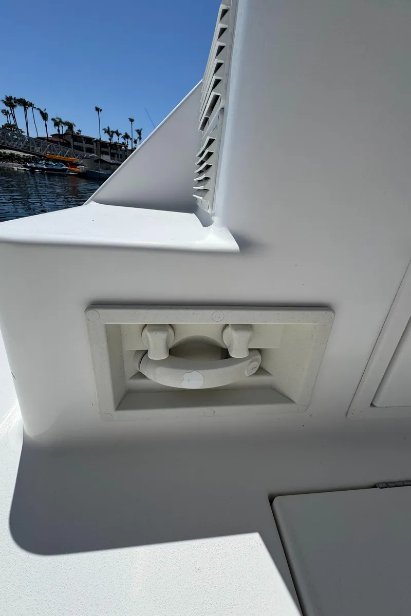 Slide: The Image of 2001 Zeta Flybridge Power Catamaran detail, featuring a white handle and sleek design. - 38