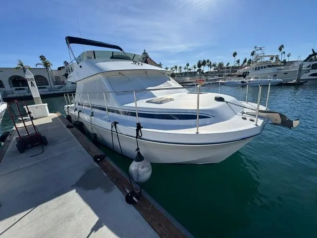 Slide: The Image of 2001 Zeta Flybridge Power Catamaran docked at marina under clear blue sky. - 4