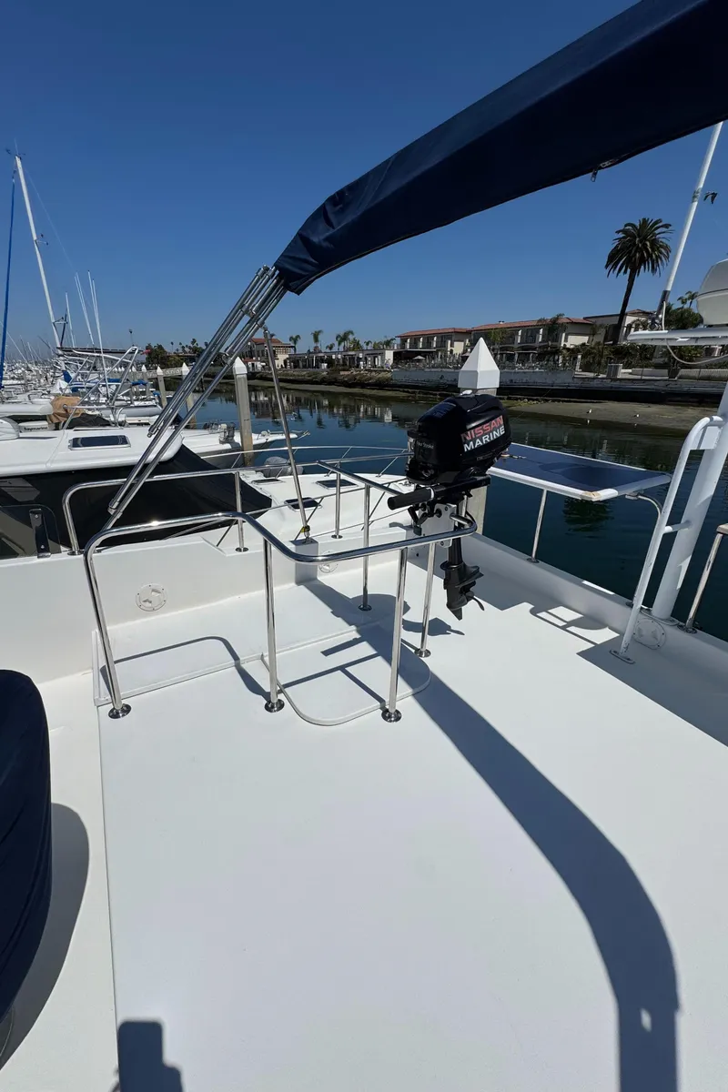 Slide: The Image of 2001 Zeta Flybridge Power Catamaran with marina view, featuring sleek design and modern equipment. - 40