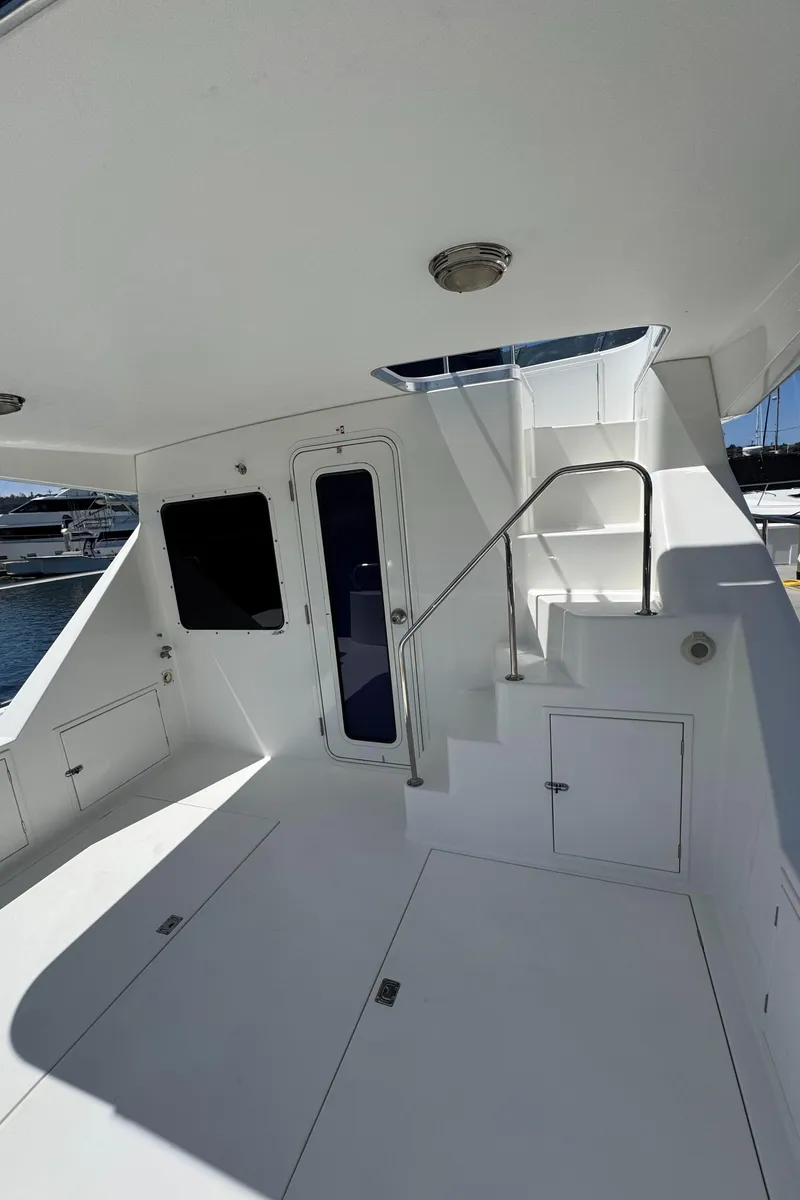 Slide: The Image of 2001 Zeta Flybridge Power Catamaran interior with stairs, sleek design, and modern fixtures. - 47