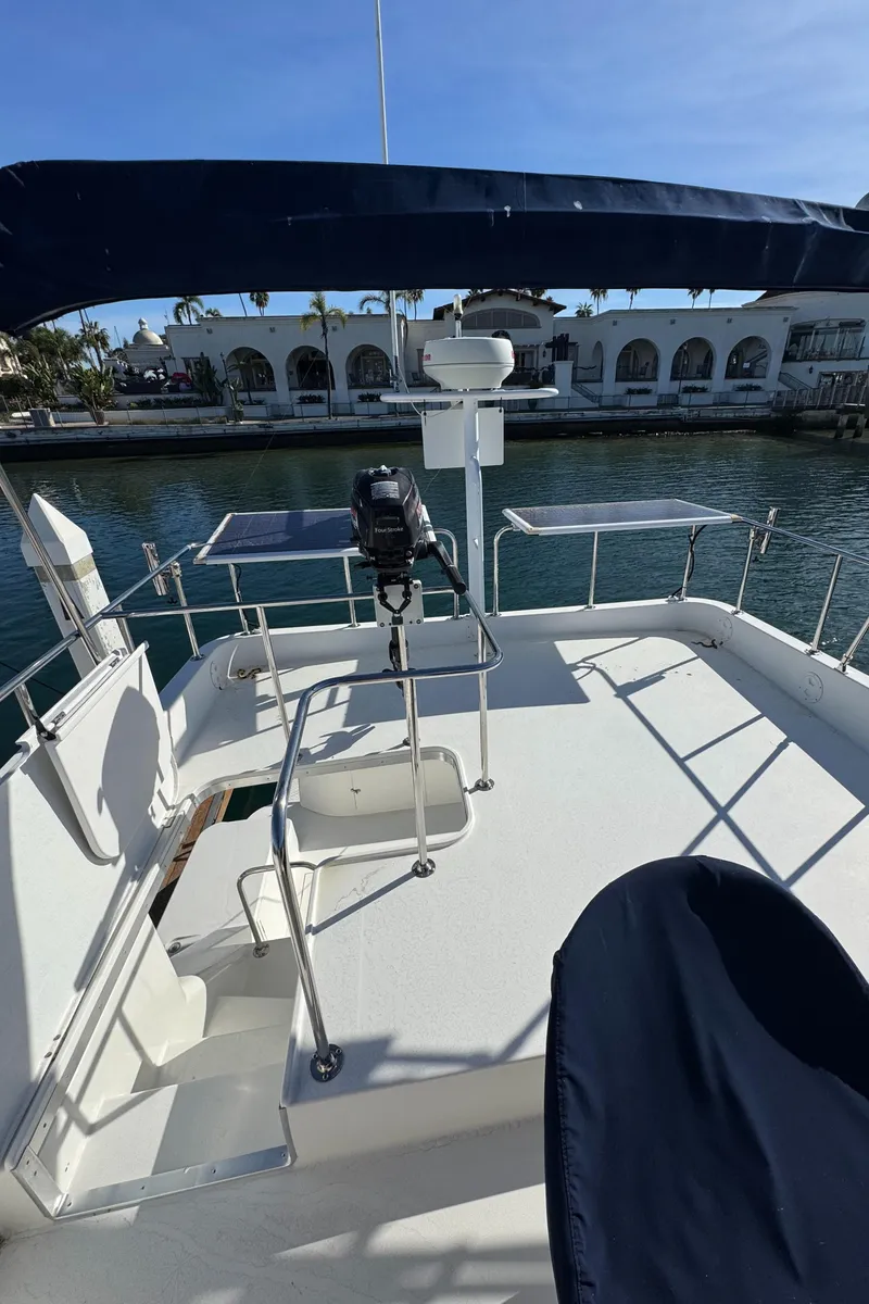 Slide: The Image of 2001 Zeta Flybridge Power Catamaran deck with seating, railing, and waterfront view. - 9