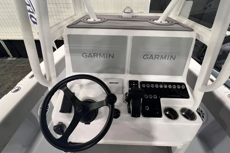 Slide: The Image of 2024 Reef Runner 230 Open boat cruising on ocean with city skyline in background. - 12