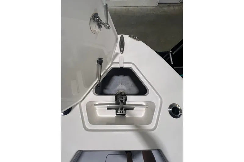 Slide: The Image of 2024 Reef Runner 230 Open boat cruising on ocean with city skyline in background. - 14