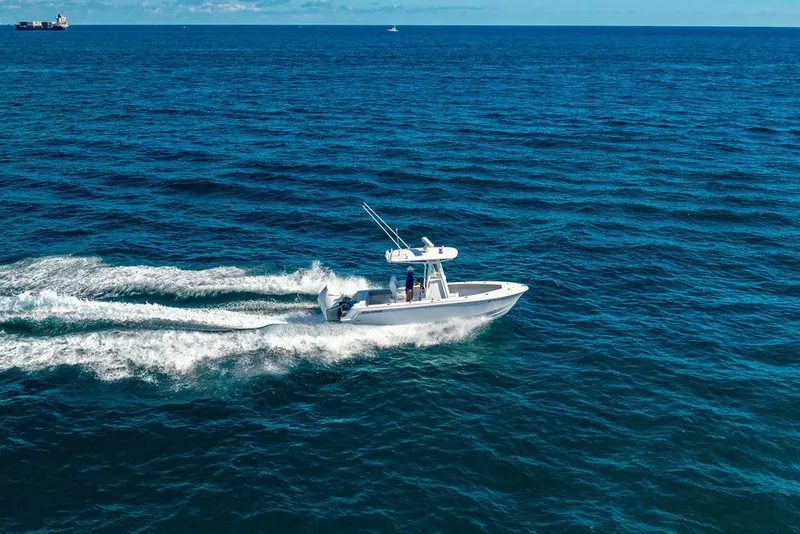 Slide: The Image of 2024 Reef Runner 230 Open boat cruising on open ocean waters. - 28