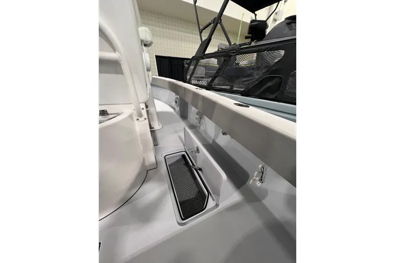 Slide: The Image of 2024 Reef Runner 230 Open boat cruising on the ocean with clear blue skies. - 3