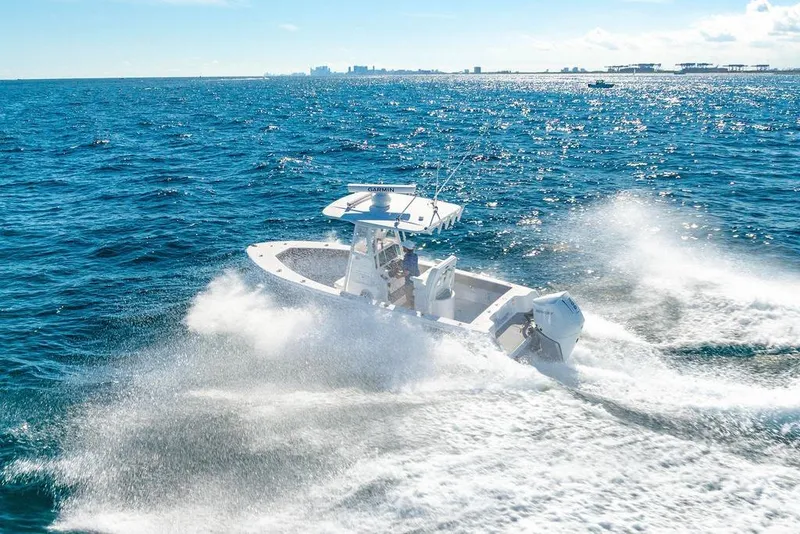 Slide: The Image of 2024 Reef Runner 230 Open boat cruising on open ocean waters. - 31