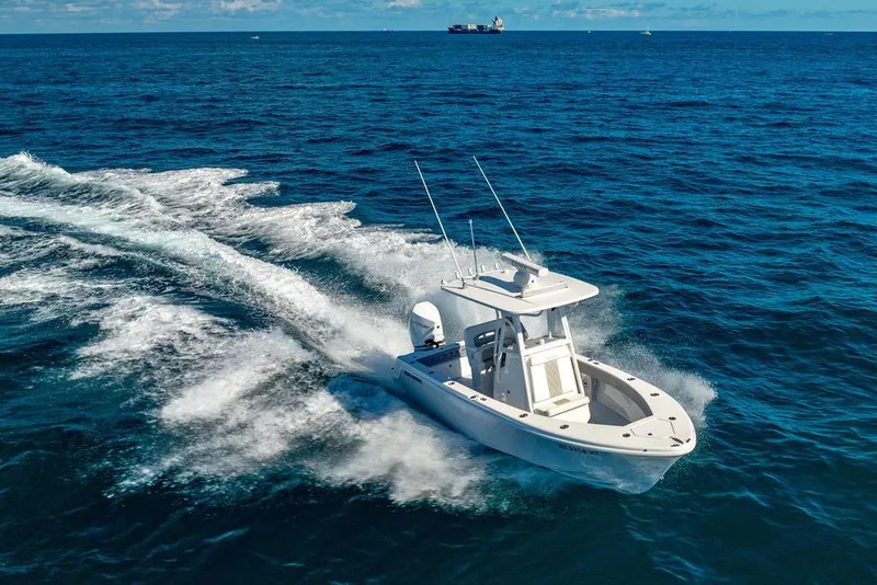 Slide: The Image of 2024 Reef Runner 230 Open boat cruising on open ocean waters. - 32