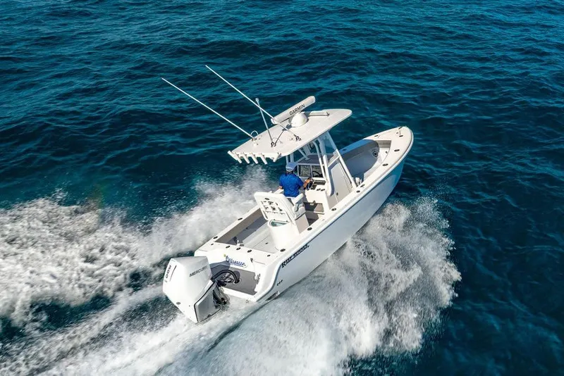 Slide: The Image of 2024 Reef Runner 230 Open boat cruising on open blue water. - 36
