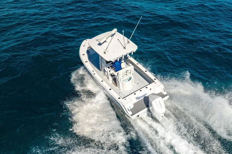 Slide: The Image of 2024 Reef Runner 230 Open boat cruising on open water, aerial view. - 37