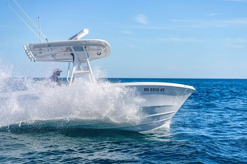 Slide: The Image of 2024 Reef Runner 230 Open boat cruising on ocean waves. - 45