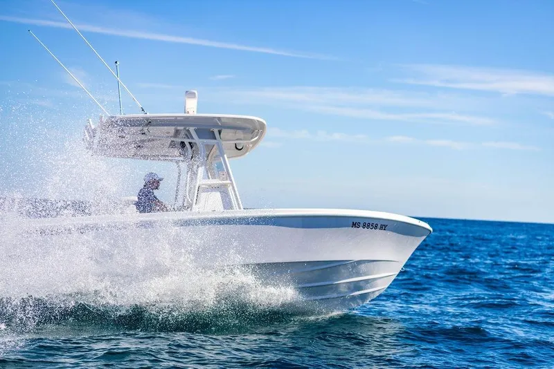 Slide: The Image of 2024 Reef Runner 230 Open boat cruising on ocean with splashing waves. - 47