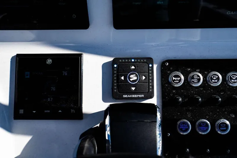 Slide: The Image of Control panel of 2024 Reef Runner 230 Open boat with Seakeeper system. - 67