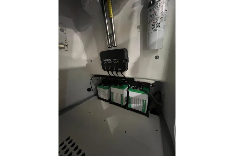 Slide: The Image of 2024 Reef Runner 230 Open boat cruising near city skyline, under a partly cloudy sky. - 8