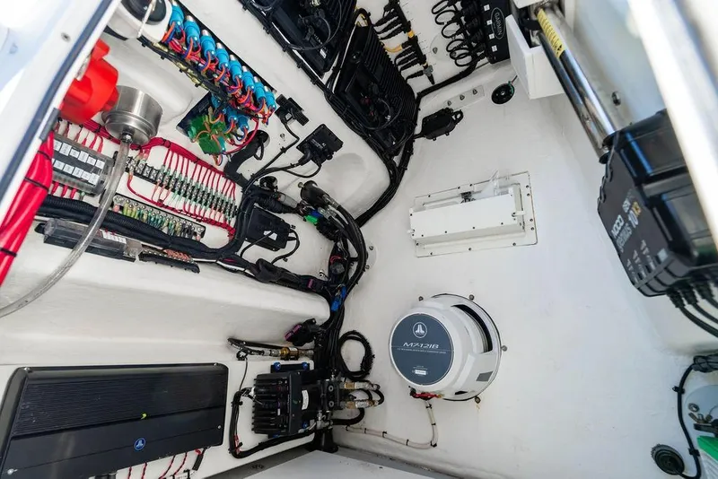 Slide: The Image of Electrical system inside 2024 Reef Runner 230 Open boat, showcasing wiring and components. - 80