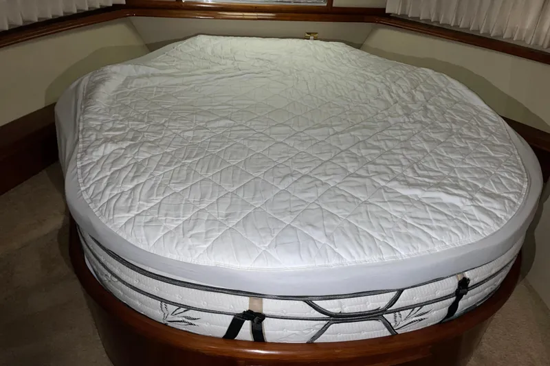 Slide: The Image of Quilted mattress in 2004 Carver 460 Voyager yacht cabin, featuring wooden trim and curtains. - 20