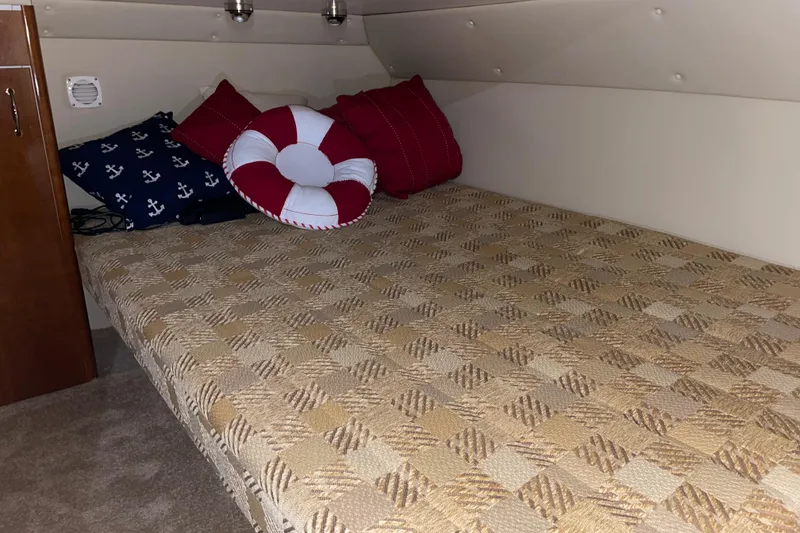 Slide: The Image of Cozy cabin bed in 2004 Carver 460 Voyager with nautical-themed pillows. - 21