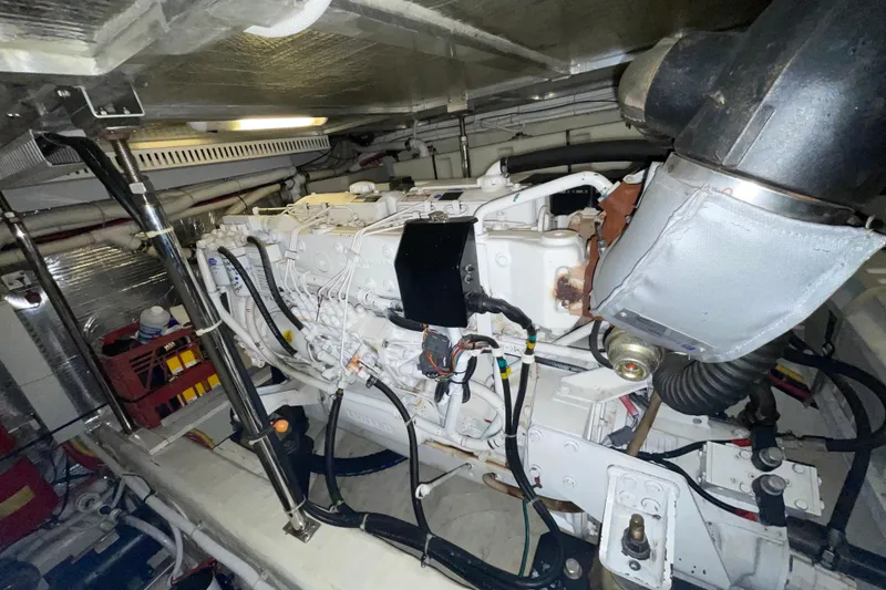 Slide: The Image of Engine room of a 2004 Carver 460 Voyager yacht, showcasing detailed machinery and components. - 24