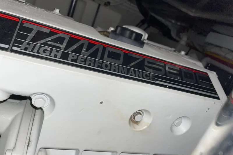 Slide: The Image of Engine detail of 2004 Carver 460 Voyager, featuring TAMD75EDC high-performance label. - 27