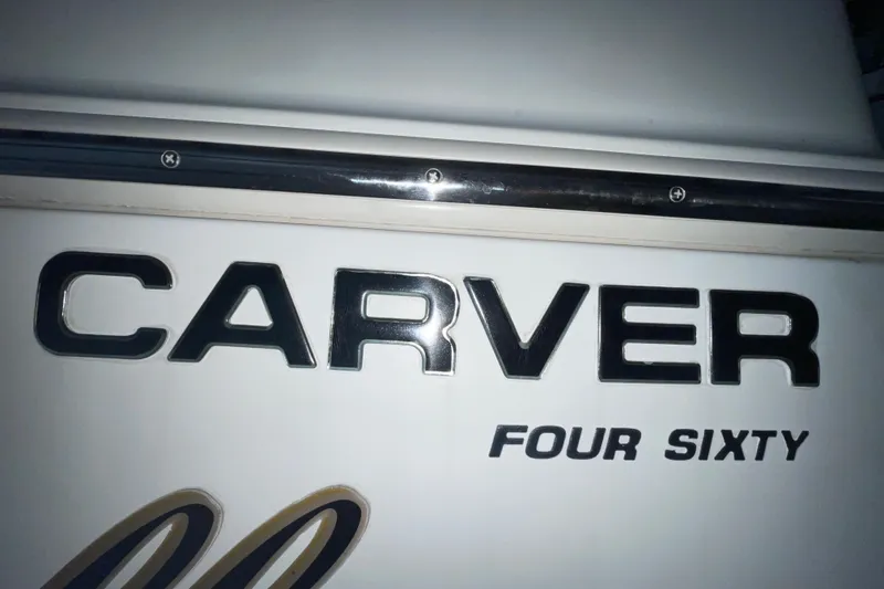 Slide: The Image of Carver 460 Voyager 2004 boat nameplate with bold lettering. - 28