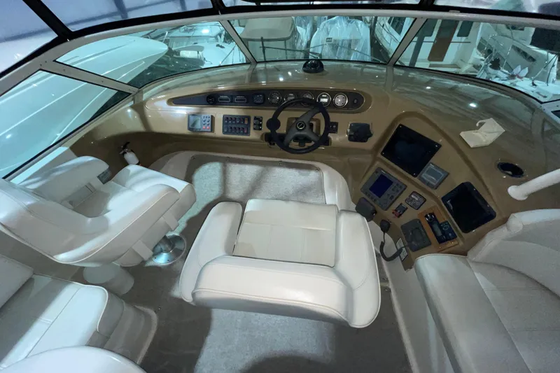 Slide: The Image of Interior cockpit of 2004 Carver 460 Voyager yacht with white seating and control panel. - 5