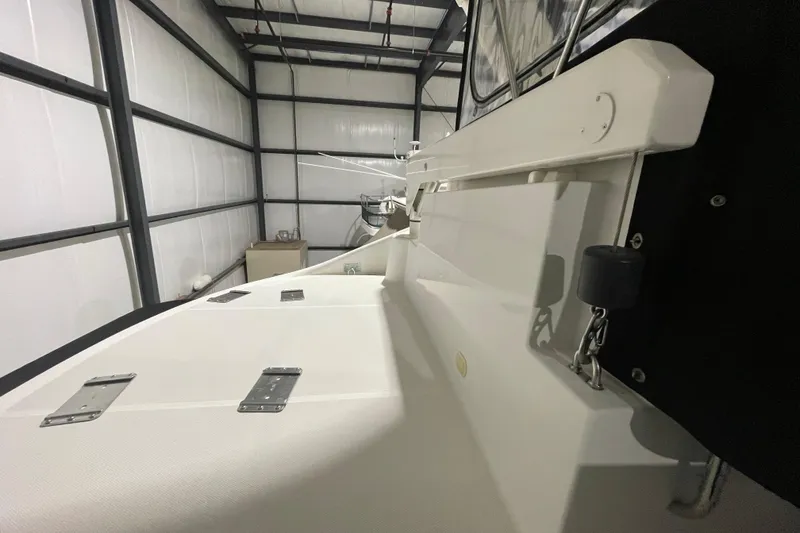 Slide: The Image of 2004 Carver 460 Voyager yacht in storage, showcasing deck and railing details. - 8