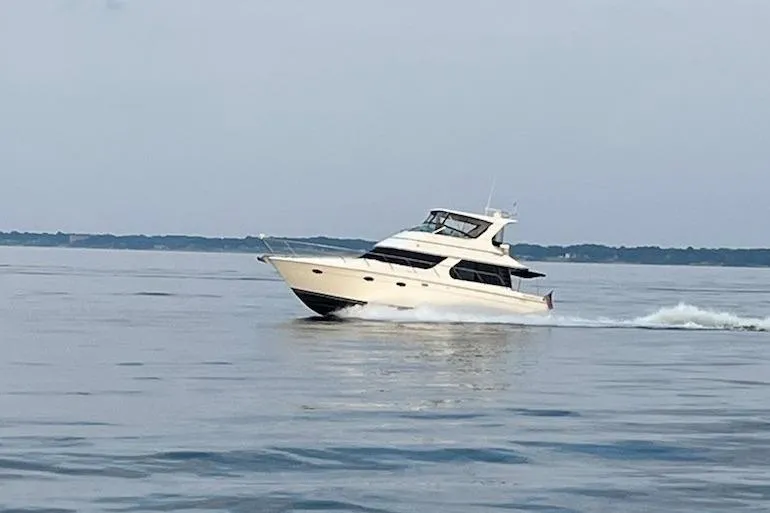 The Image of 2004 Carver 460 Voyager yacht cruising on calm waters. - 0