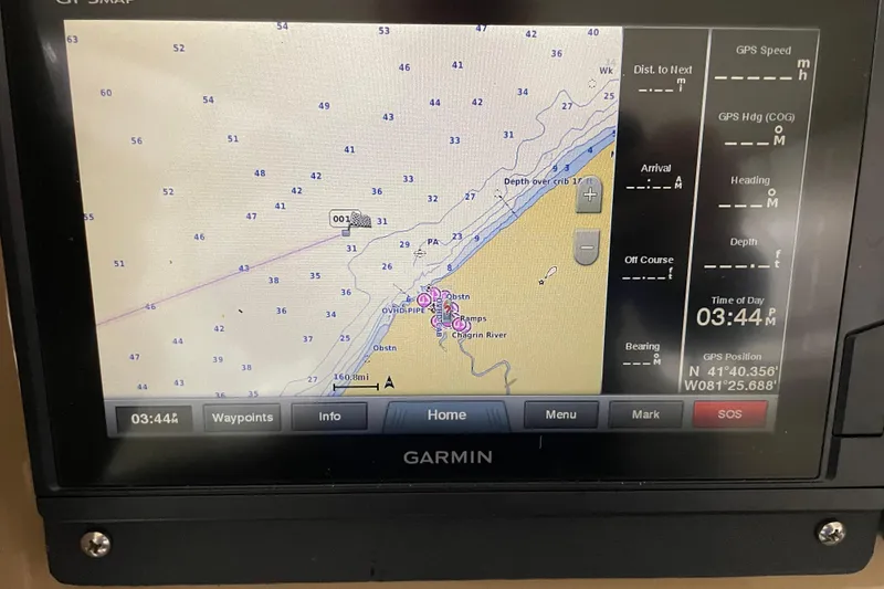 Slide: The Image of Garmin GPS display on 2004 Carver 460 Voyager, showing nautical map and coordinates. - 10