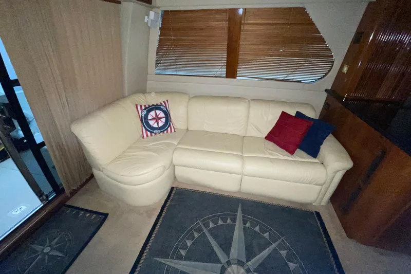 Slide: The Image of Luxurious interior of 2004 Carver 460 Voyager with cream leather sofa and nautical-themed decor. - 13