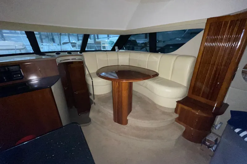 Slide: The Image of Interior of 2004 Carver 460 Voyager yacht with elegant seating and wooden table. - 14