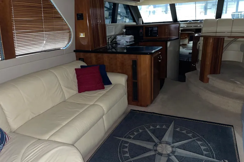 Slide: The Image of Interior of 2004 Carver 460 Voyager yacht with cream sofa and nautical-themed decor. - 15