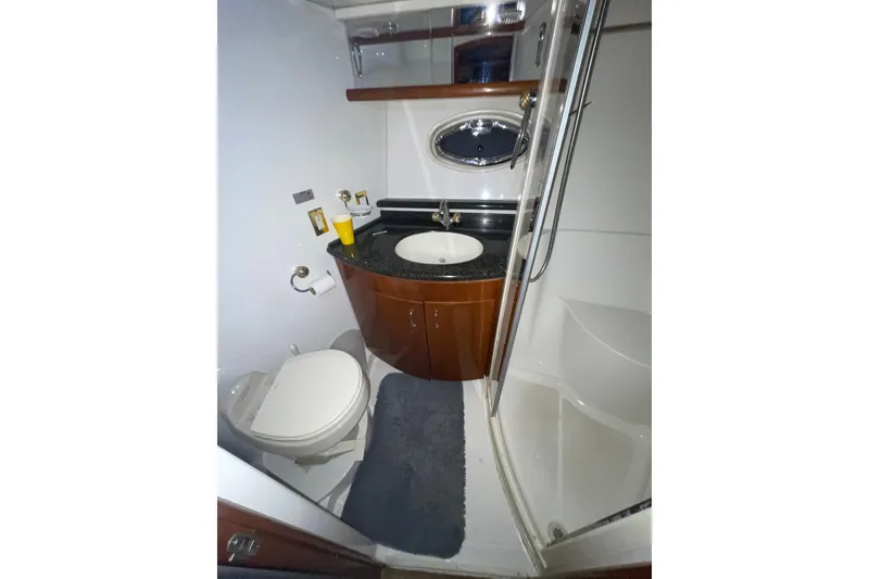 Slide: The Image of Bathroom interior of 2004 Carver 460 Voyager yacht with sink, toilet, and shower. - 19