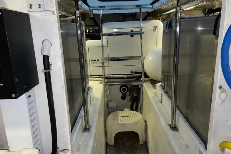Slide: The Image of Engine room of 2004 Carver 460 Voyager with Kohler power system and ladder access. - 26