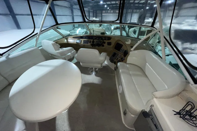 Slide: The Image of Interior of 2004 Carver 460 Voyager yacht with white seating and helm station. - 6