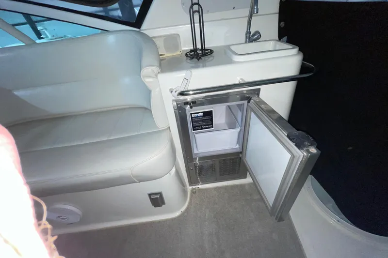 Slide: The Image of Interior of 2004 Carver 460 Voyager with open mini fridge and seating area. - 7
