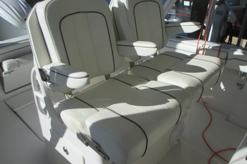 Slide: The Image of 2012 Jupiter 30 FS boat interior with white cushioned seating and armrests. - 12