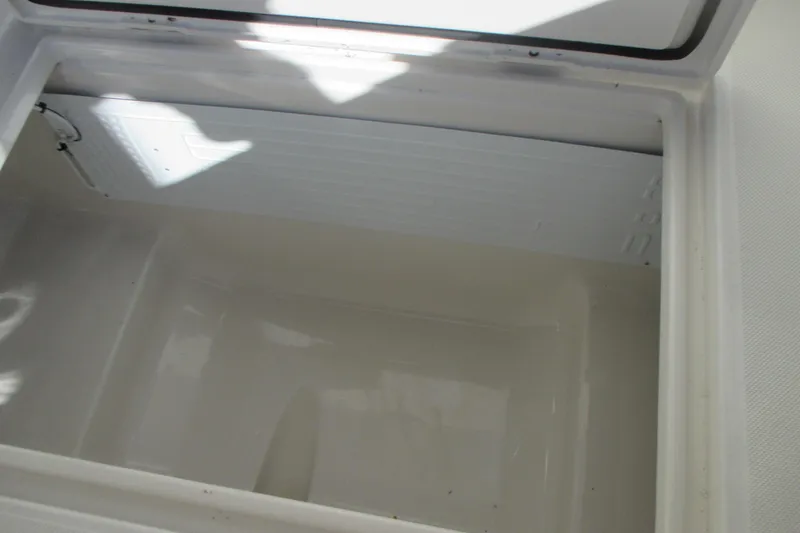 Slide: The Image of Open storage compartment in 2012 Jupiter 30 FS boat, showing clean interior space. - 15