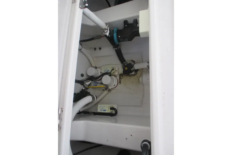 Slide: The Image of Bilge area of 2012 Jupiter 30 FS boat with visible plumbing components. - 16
