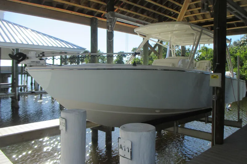 Slide: The Image of 2012 Jupiter 30 FS boat docked under a wooden shelter. - 4