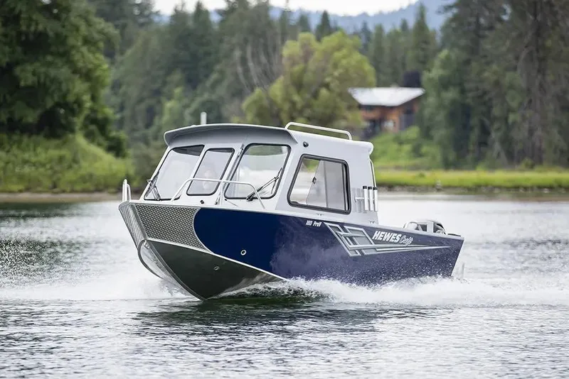 Slide: The Image of 2026 Hewescraft 200 ProV ET HT boat cruising on a scenic lake. - 12