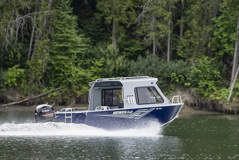 Slide: The Image of 2026 Hewescraft 200 ProV ET HT boat cruising on a lake with forest backdrop. - 13
